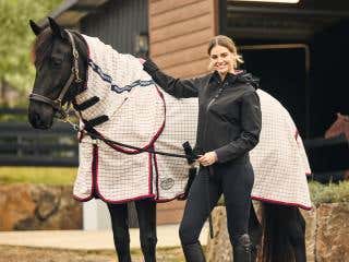 Woman poses with black horse wearing a WeatherBeeta Lite Summer Sheet