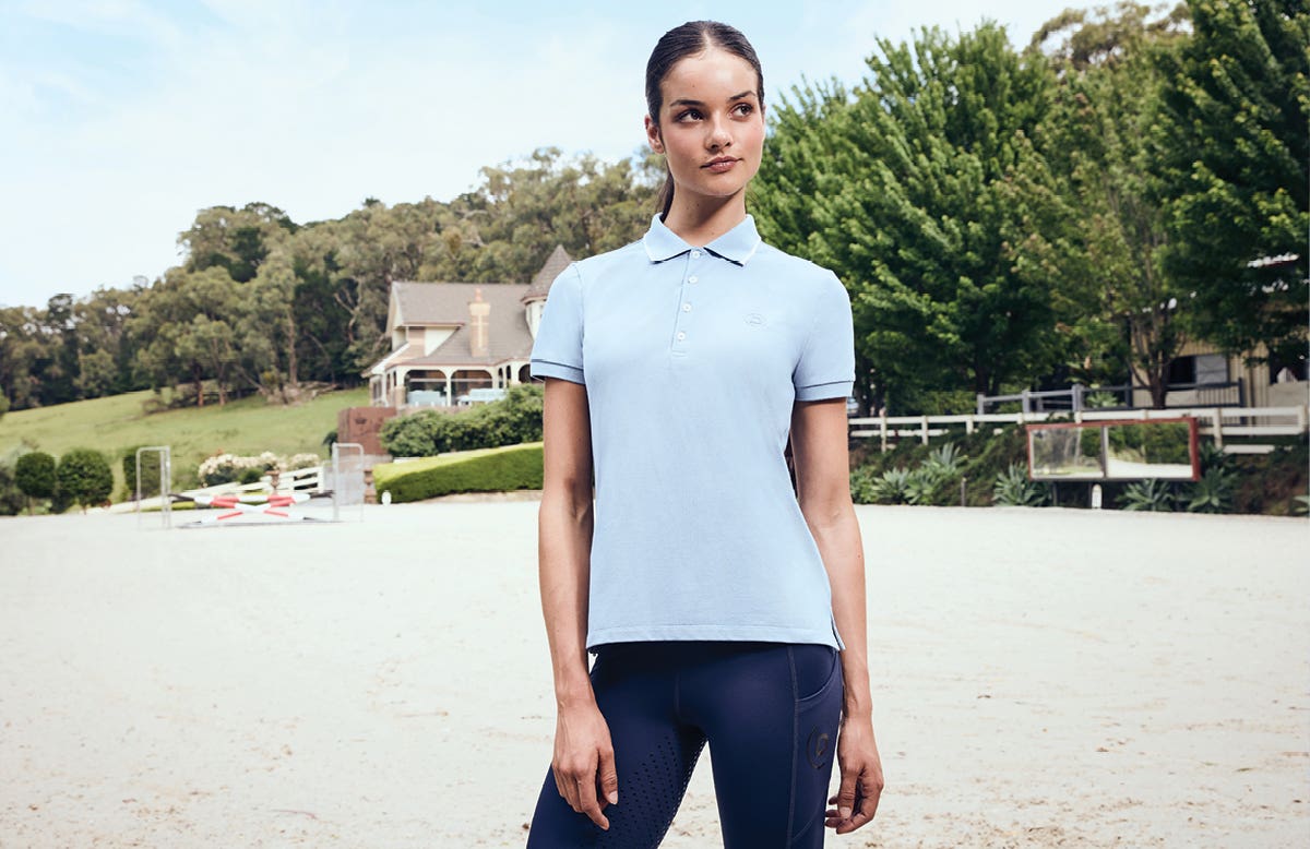 Model wearing Dublin Cotton Pique Short Sleeve Polo standing in an arena