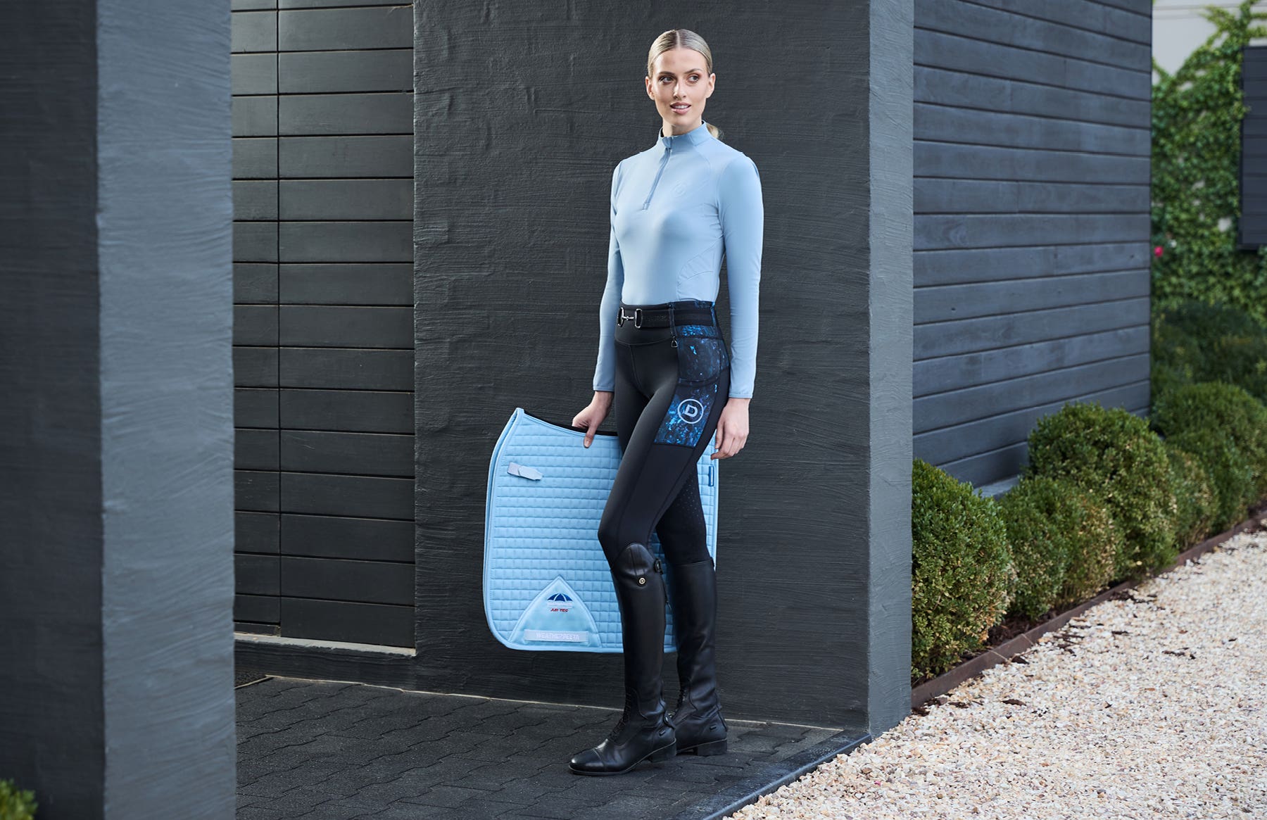 Model holding saddle pad wearing new Dublin Form tights