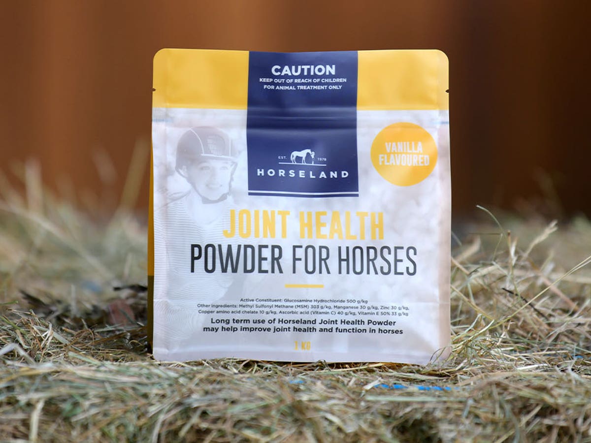 Horseland’s Joint Health Powder For Horses sitting on hay bale in stable