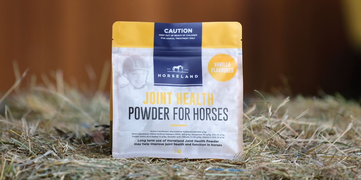 Horseland’s Joint Health Powder For Horses sitting on hay bale in stable